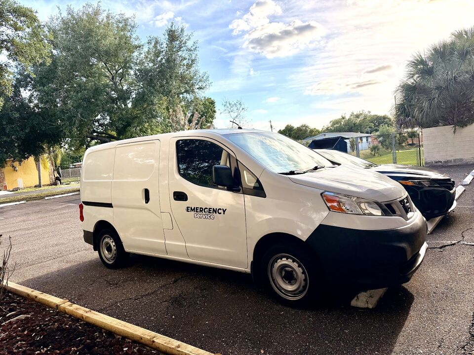 A white service van parked on a street